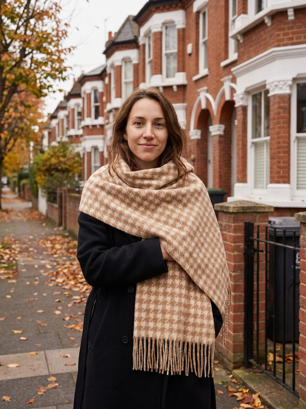 Woman wrapped in the camel Houndstooth Blanket Scarf on an autumn street