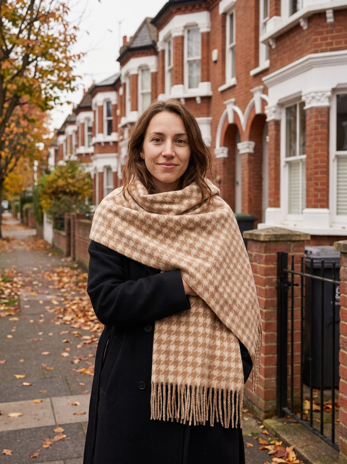 Woman wrapped in the camel Houndstooth Blanket Scarf on an autumn street