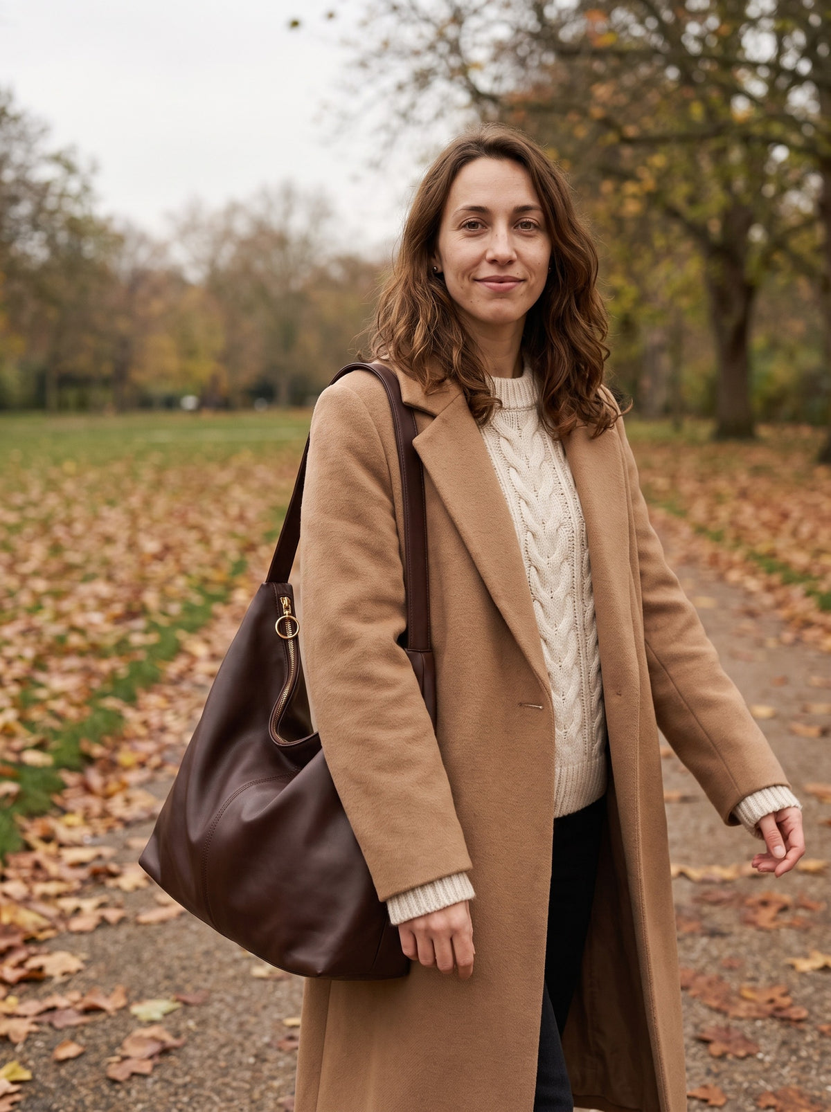 Woman carrying the chocolate Slouch Hobo Bag on her shoulder