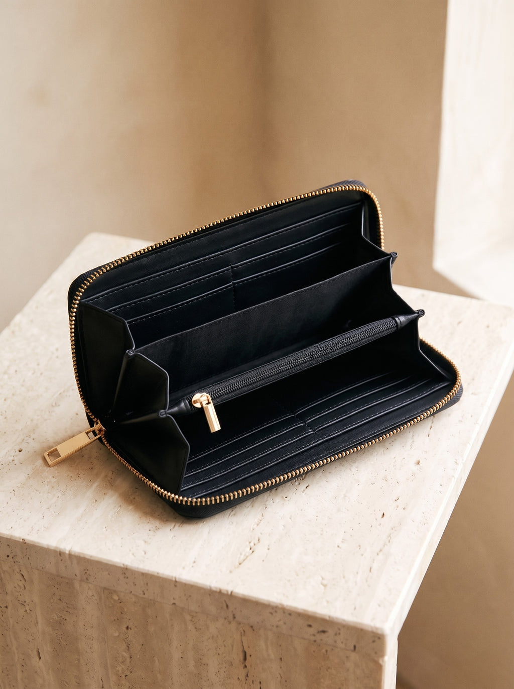 The black Zip-Around Wallet open, showing its card slots and zipped coin pocket